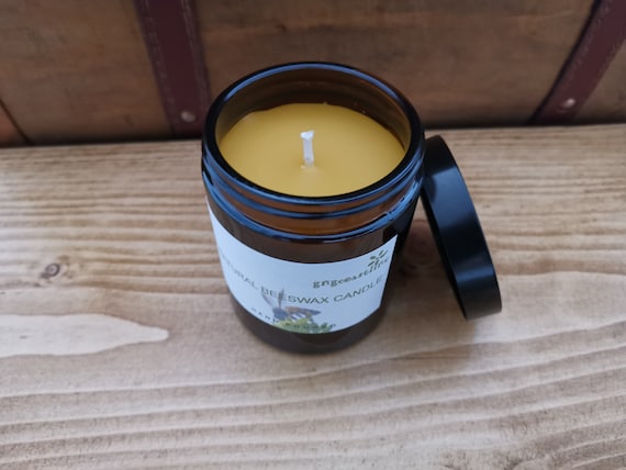 Beeswax Candle In An Brown Glass Jar With Black Lid