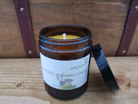 Beeswax Candle In An Brown Glass Jar With Black Lid