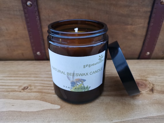 Beeswax Candle In An Brown Glass Jar With Black Lid
