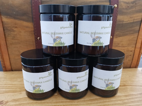 Beeswax Candle In An Brown Glass Jar With Black Lid