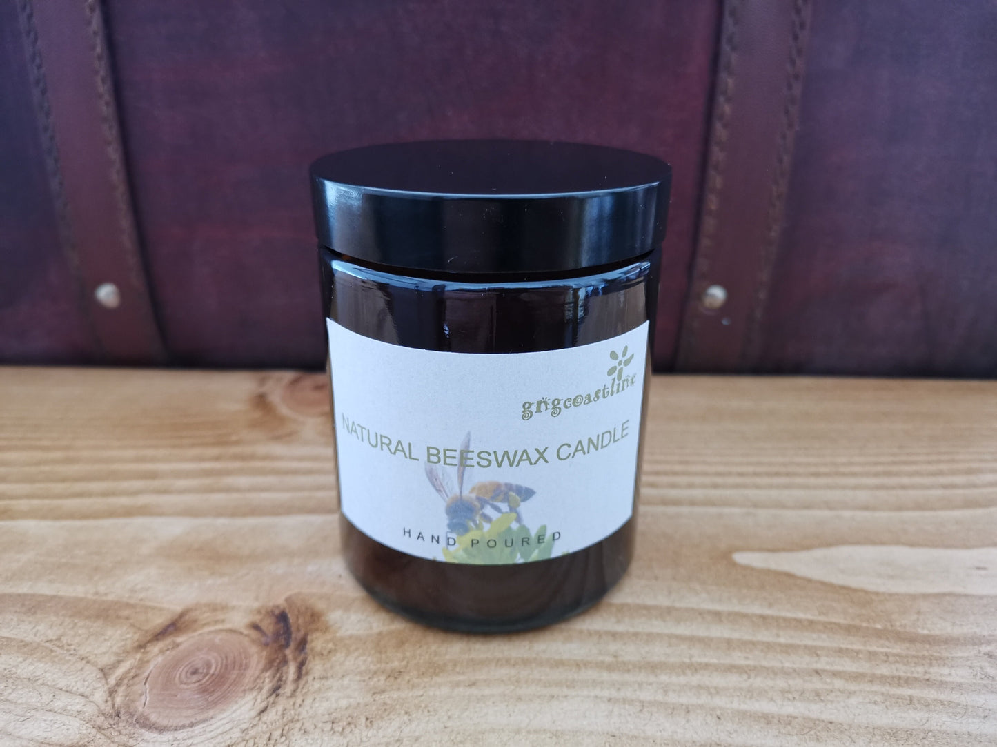 Beeswax Candle In An Brown Glass Jar With Black Lid