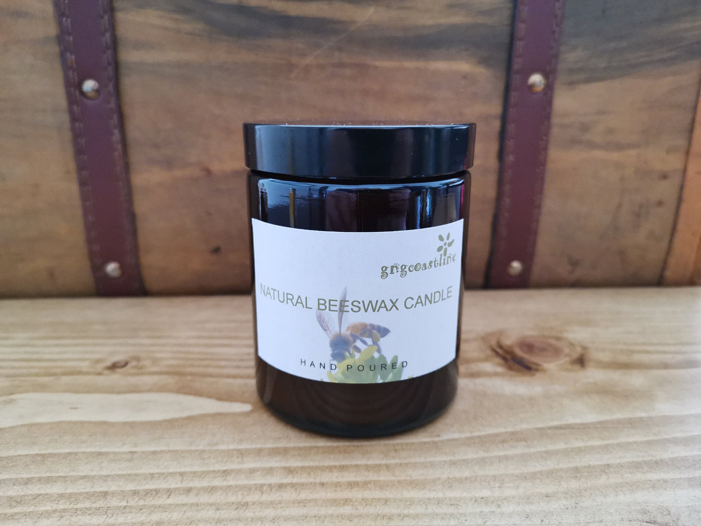 Beeswax Candle In An Brown Glass Jar With Black Lid