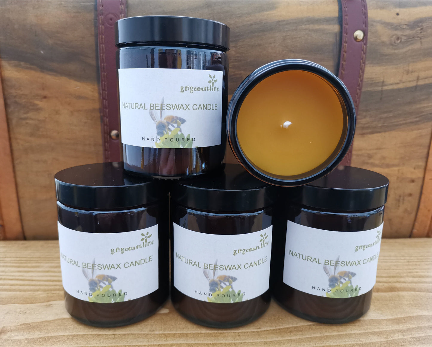Beeswax Candle In An Brown Glass Jar With Black Lid