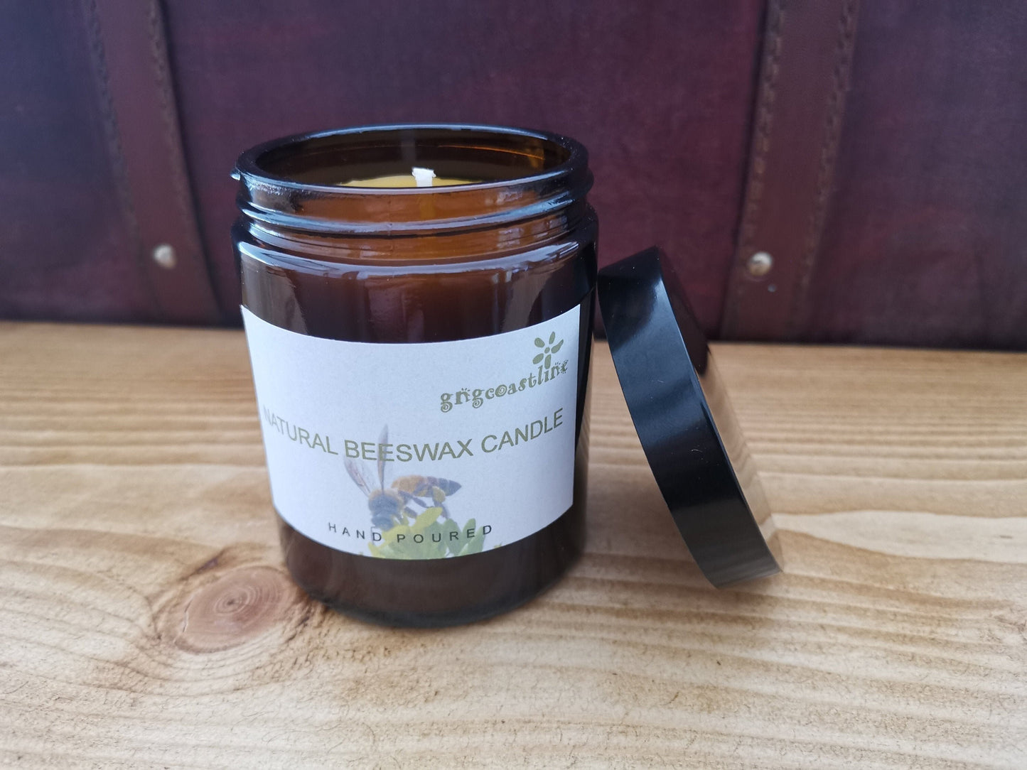 Beeswax Candle In An Brown Glass Jar With Black Lid