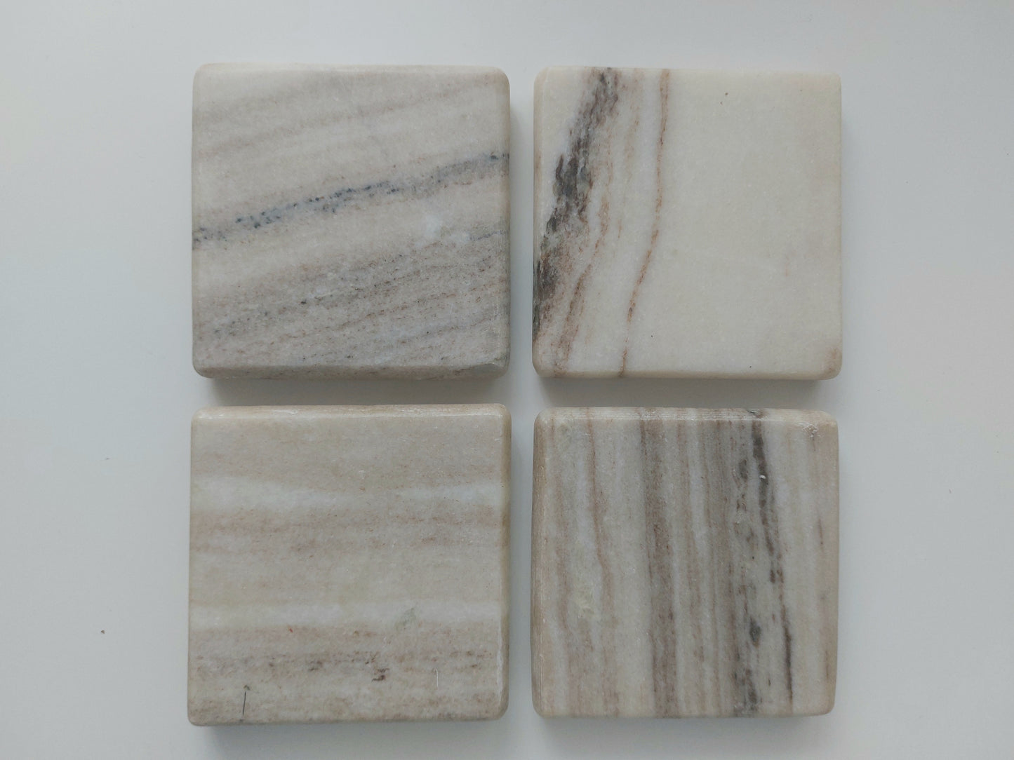 Smooth, matte, natural marble coasters, mix of beige, cream to brown colour