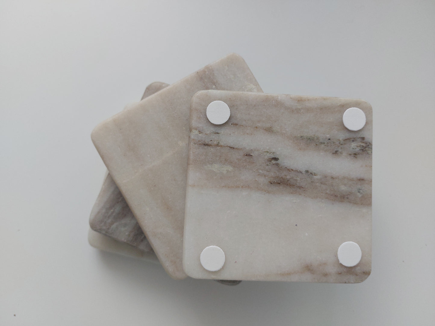 Smooth, matte, natural marble coasters, mix of beige, cream to brown colour