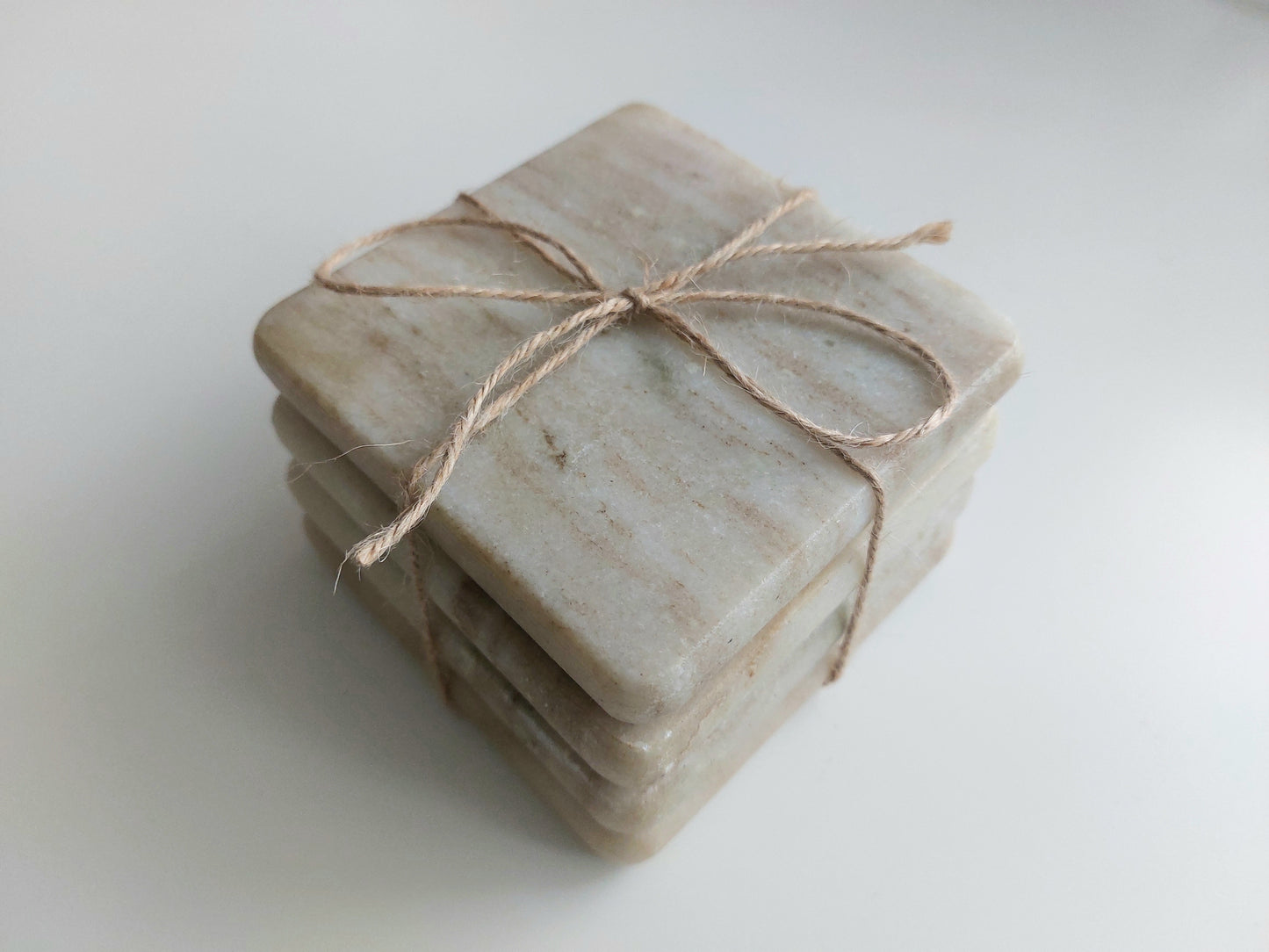 Smooth, matte, natural marble coasters, mix of beige, cream to brown colour