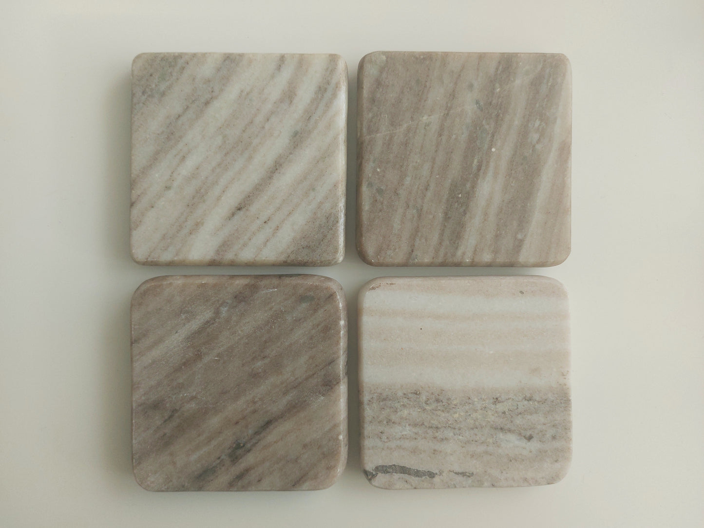 Smooth, matte, natural marble coasters, mix of beige, cream to brown colour